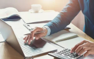 businessman working in office with using calculator and laptop. concept finance and accounting