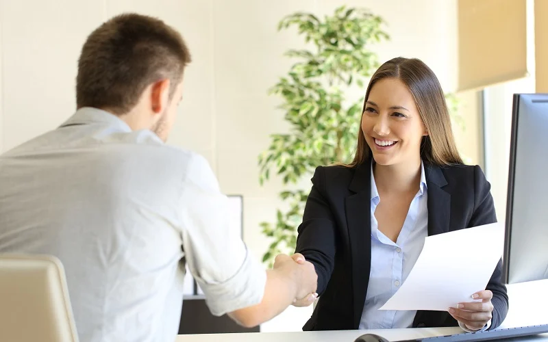 Successful career conversation with boss and employee handshaking