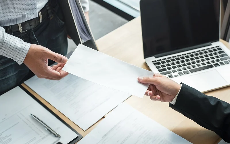 Businessman sending a resignation letter to employer boss in order to resign dismiss contract, changing and resigning from work concept