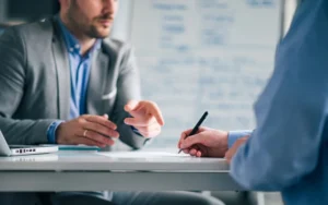 Business people negotiating, signing a contract, close up.