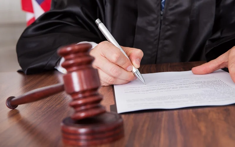 Male Judge Writing On Paper