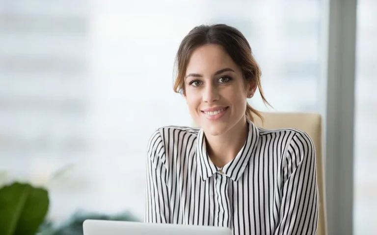 Portrait of smiling confident female boss looking at camera