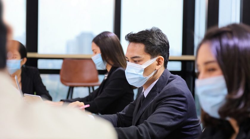 Asian people working together in co-working space following social distancing and new normal policy by wearing facial mask in the business office workplace during covid-19 outbreak