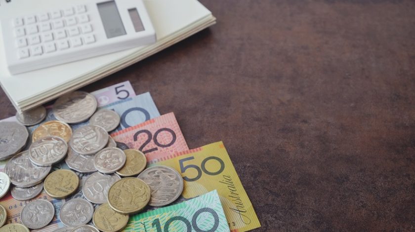 Australian money, AUD  calculator, and notebook, copy space background