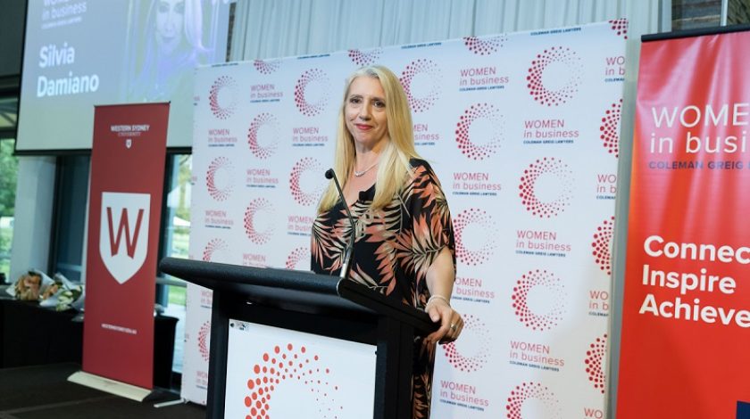 Keynote speaker, Silvia Damiano standing at the lectern at the Women in Business event.