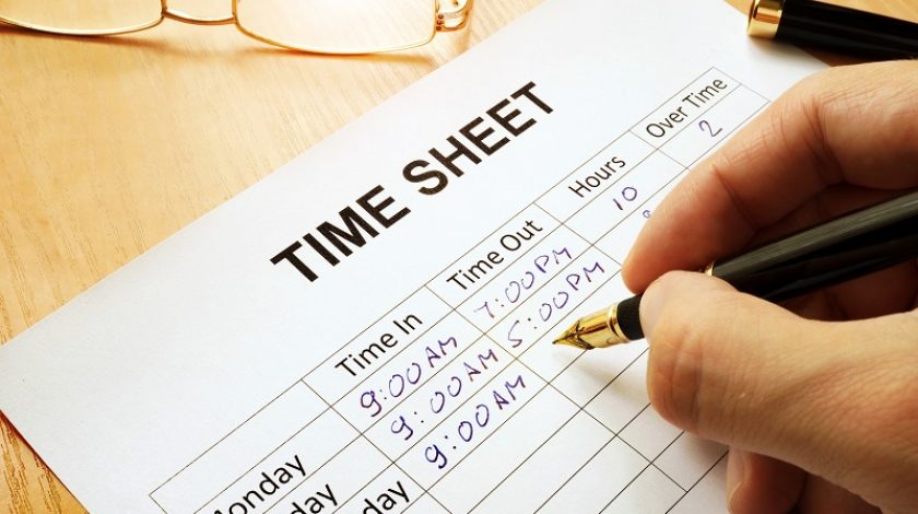 Records work hours in a time sheet.