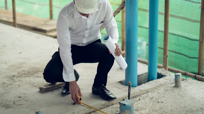 Engineer checking defect in construction site measure offset distance of sleeve of soil pvc pipe