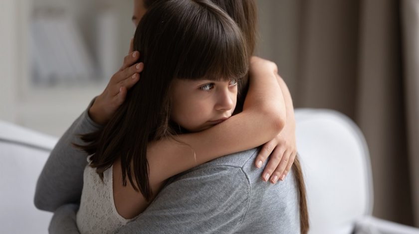 Close up view of upset little daughter cuddling mother, child receiving protection and support from mommy, adopted kid girl and new parent, sole custody, offspring and motherhood connection concept