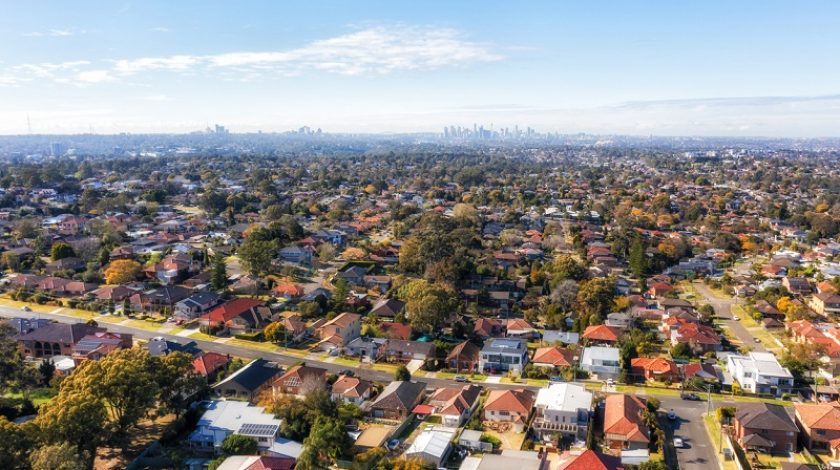 City of Ryde residential suburbs of Greater Sydney in Australia - aerial view towards distant city CBD on horizon.