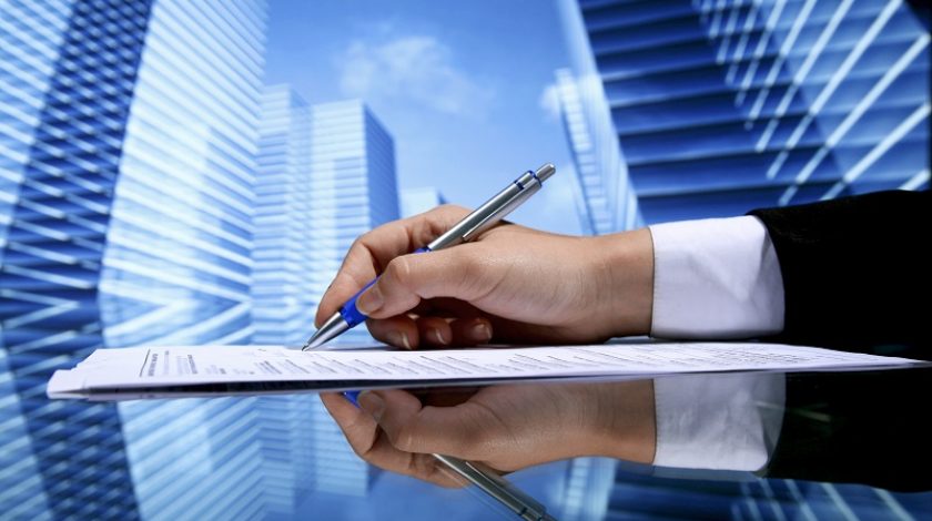 Realtor signing contract on skyscrapers background