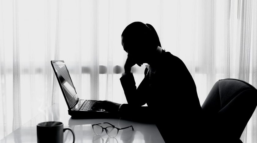 silhouette of Businesswoman using computer in the office. Stress in the office