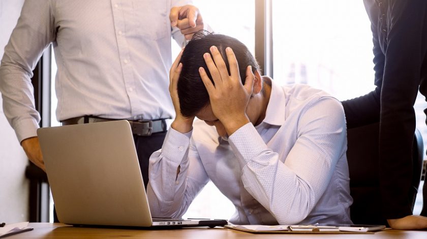 Business people blaming frustrated male colleague in Office. Negative human emotions concept