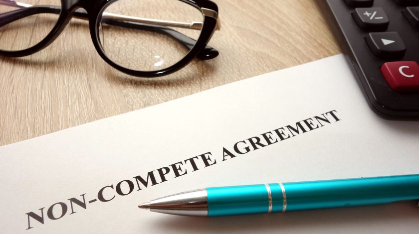Non-compete agreement document for filling and signing on desk, 
business competition concept